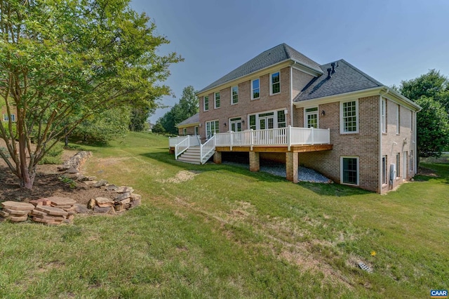 455 Foxdale Ln, Charlottesville, VA 22903 - rear view of house with brick siding, a wooden deck, a lawn, and roof with shingles