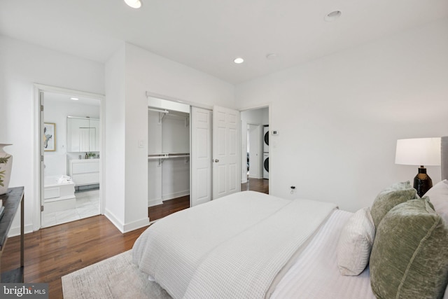 1200 6th St NE, Washington, DC 20002 - bedroom with stacked washer / dryer, wood finished floors, recessed lighting, ensuite bathroom, and a closet