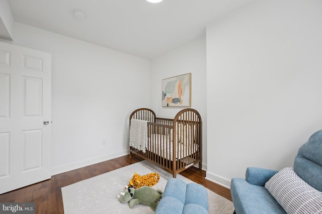 1200 6th St NE, Washington, DC 20002 - bedroom with dark wood-style flooring and a crib