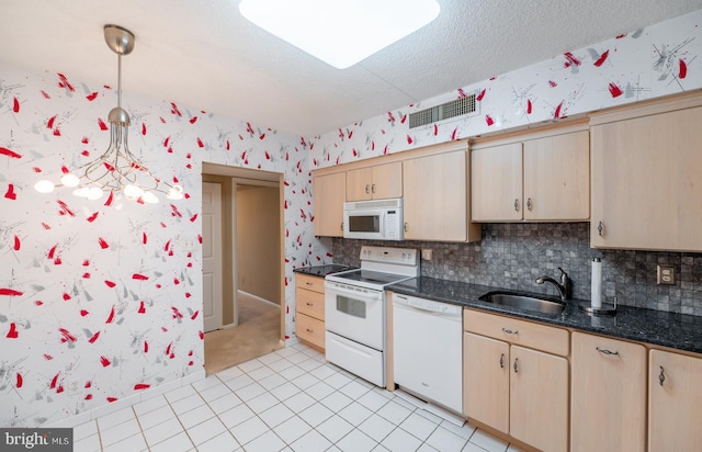 20630 Valley Forge Cir Unit 630, King Of Prussia, PA 19406 - kitchen featuring white appliances, light brown cabinetry, hanging light fixtures, wallpapered walls, and decorative backsplash