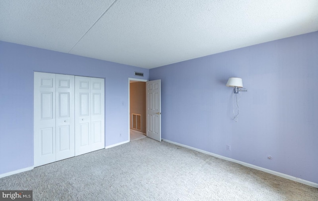 20630 Valley Forge Cir Unit 630, King Of Prussia, PA 19406 - unfurnished bedroom featuring carpet floors, a textured ceiling, and a closet
