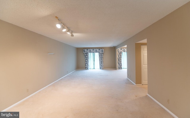 20630 Valley Forge Cir Unit 630, King Of Prussia, PA 19406 - empty room featuring light colored carpet, track lighting, and a textured ceiling