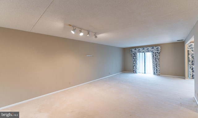 20630 Valley Forge Cir Unit 630, King Of Prussia, PA 19406 - unfurnished room with light colored carpet, rail lighting, and a textured ceiling