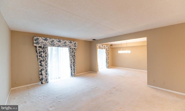 20630 Valley Forge Cir Unit 630, King Of Prussia, PA 19406 - unfurnished room with light colored carpet, a chandelier, and a textured ceiling