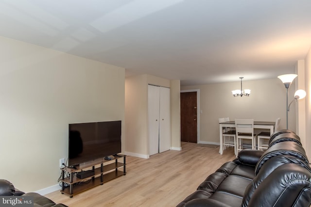200 Highland Ave Unit 203, State College, PA 16801 - living room with a chandelier and light wood finished floors