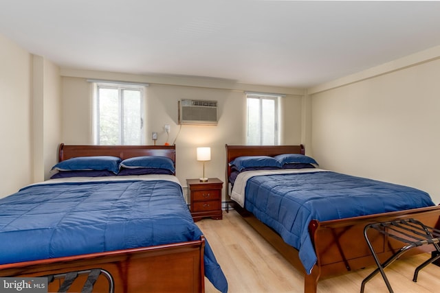 200 Highland Ave Unit 203, State College, PA 16801 - bedroom featuring wood finished floors and a wall unit AC