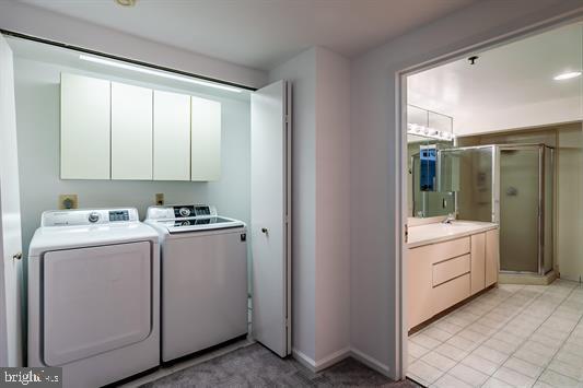 3101 Boardwalk Unit 3402-2, Atlantic City, NJ 08401 - washroom featuring washer and dryer, cabinet space, and light tile patterned floors