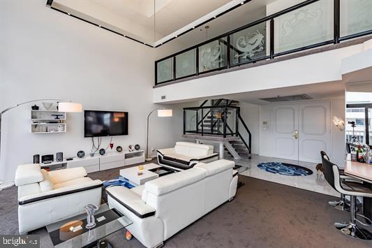 3101 Boardwalk Unit 3402-2, Atlantic City, NJ 08401 - carpeted living area with a towering ceiling and stairway