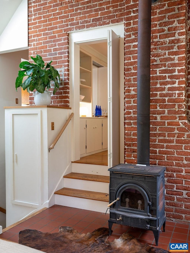 1614 Meadowbrook Heights Rd, Charlottesville, VA 22901 - stairs featuring a wood stove, tile patterned flooring, and brick wall