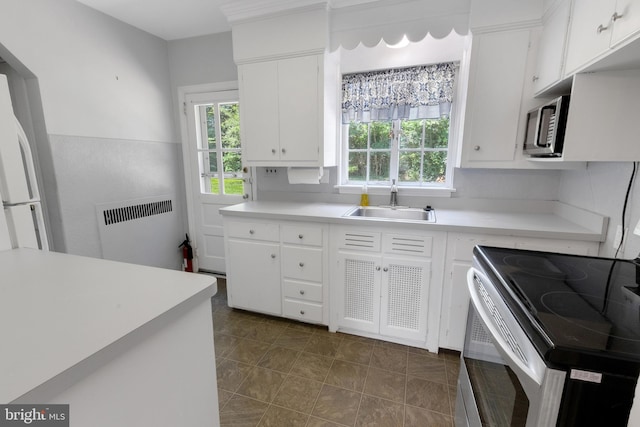 509 Baynard Blvd, Wilmington, DE 19803 - kitchen with appliances with stainless steel finishes, radiator, healthy amount of natural light, and light countertops