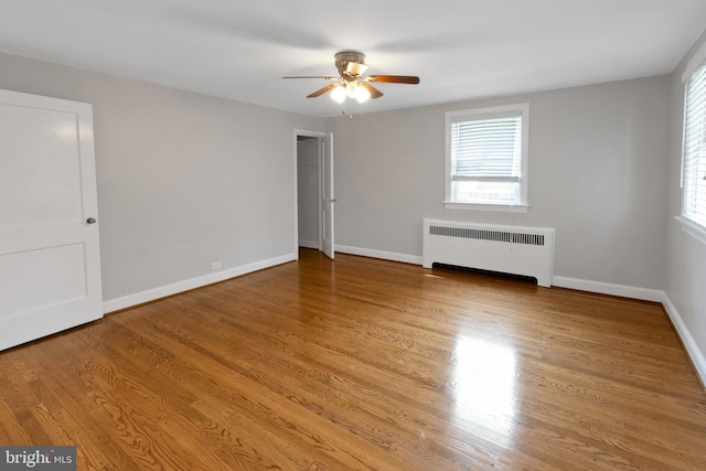 509 Baynard Blvd, Wilmington, DE 19803 - unfurnished bedroom featuring radiator, multiple windows, light wood finished floors, and a ceiling fan