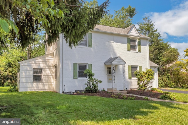 509 Baynard Blvd, Wilmington, DE 19803 - view of front of house with brick siding, a front yard, and roof with shingles