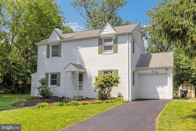 509 Baynard Blvd, Wilmington, DE 19803 - traditional home featuring a garage, a chimney, driveway, and a front lawn