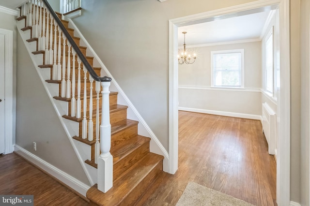 509 Baynard Blvd, Wilmington, DE 19803 - stairs with ornamental molding, wood finished floors, and a chandelier