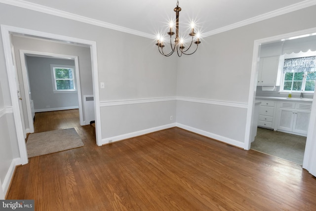 509 Baynard Blvd, Wilmington, DE 19803 - unfurnished dining area featuring a chandelier, plenty of natural light, dark wood-type flooring, and ornamental molding