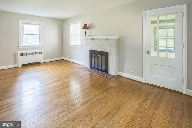 509 Baynard Blvd, Wilmington, DE 19803 - unfurnished living room with radiator, a fireplace, and wood finished floors