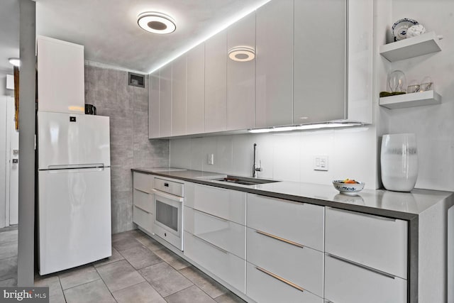 2800 Wisconsin Ave NW Unit 304, Washington, DC 20007 - kitchen with white appliances, white cabinets, modern cabinets, and open shelves