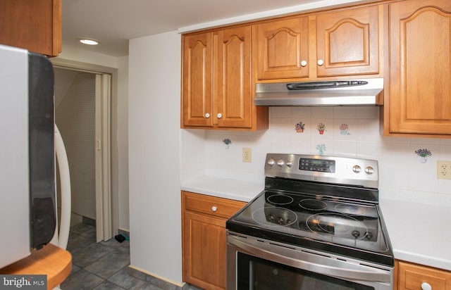 4239 Elbridge St, Philadelphia, PA 19135 - kitchen with stainless steel range with electric stovetop, fridge, under cabinet range hood, light countertops, and tasteful backsplash
