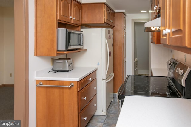 4239 Elbridge St, Philadelphia, PA 19135 - kitchen with stainless steel appliances, under cabinet range hood, brown cabinetry, light countertops, and decorative backsplash