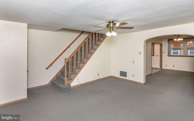 4239 Elbridge St, Philadelphia, PA 19135 - unfurnished living room with ceiling fan, stairway, carpet floors, a textured ceiling, and arched walkways