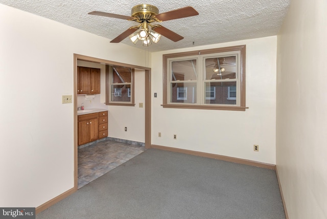 4239 Elbridge St, Philadelphia, PA 19135 - empty room with dark colored carpet, a ceiling fan, and a textured ceiling
