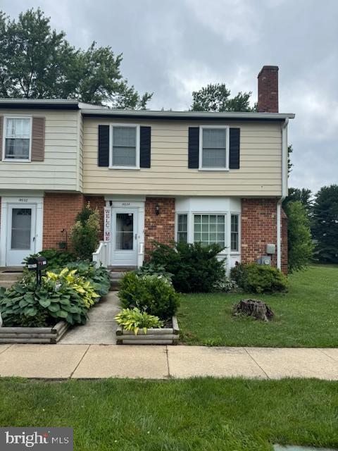18624 Grosbeak Ter, Gaithersburg, MD 20879 - colonial house with brick siding, a chimney, and a front yard