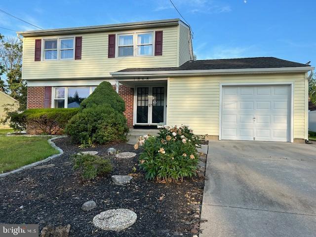 1868 W Point Dr, Cherry Hill, NJ 08003 - traditional-style home with a garage, french doors, concrete driveway, and brick siding