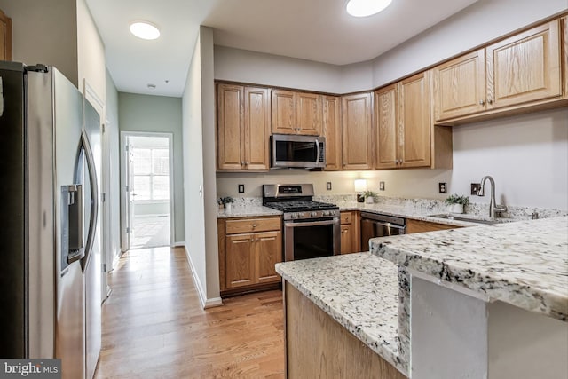 1869 Cedar Cove Way Unit 101, Woodbridge, VA 22191 - kitchen with appliances with stainless steel finishes, light stone counters, and light wood-style floors