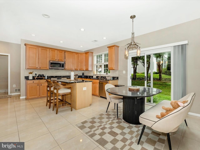 14228 Golden Hook Rd, Boyds, MD 20841 - kitchen featuring appliances with stainless steel finishes, a center island, tasteful backsplash, light tile patterned floors, and recessed lighting