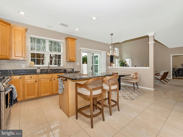 14228 Golden Hook Rd, Boyds, MD 20841 - kitchen featuring stainless steel range, tasteful backsplash, a kitchen island, plenty of natural light, and recessed lighting