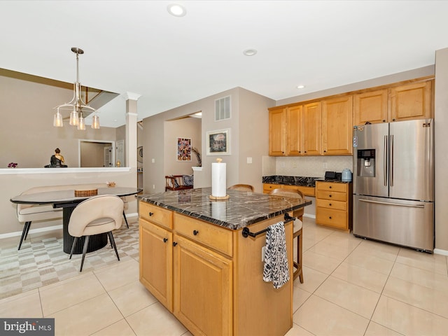 14228 Golden Hook Rd, Boyds, MD 20841 - kitchen with stainless steel fridge, dark countertops, light tile patterned floors, a center island, and tasteful backsplash