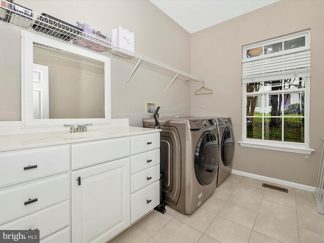 14228 Golden Hook Rd, Boyds, MD 20841 - laundry room featuring washing machine and dryer, light tile patterned floors, and cabinet space