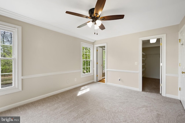 11021 Folksie Ct Unit 201, Manassas, VA 20109 - unfurnished bedroom featuring a spacious closet, carpet, ceiling fan, and a closet