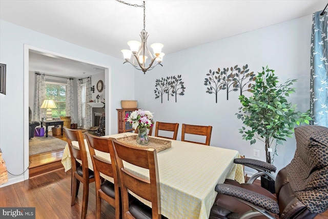 69 Cardinal Forest Dr, Fredericksburg, VA 22406 - dining space with dark wood-style floors, a chandelier, and a fireplace