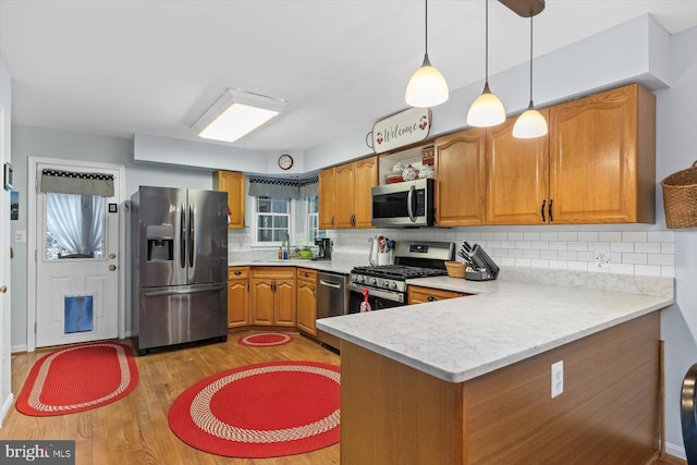 69 Cardinal Forest Dr, Fredericksburg, VA 22406 - kitchen with appliances with stainless steel finishes, light countertops, light wood-style floors, and brown cabinetry