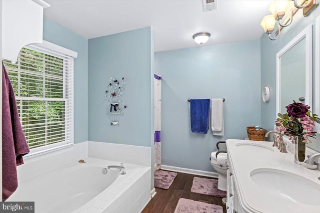 69 Cardinal Forest Dr, Fredericksburg, VA 22406 - full bathroom with healthy amount of natural light, a garden tub, wood finished floors, and double vanity