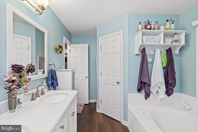69 Cardinal Forest Dr, Fredericksburg, VA 22406 - bathroom featuring a bath, double vanity, and wood finished floors