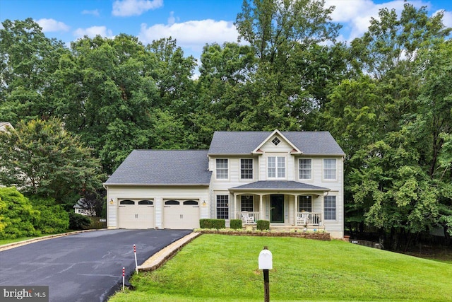 69 Cardinal Forest Dr, Fredericksburg, VA 22406 - colonial home with a porch, asphalt driveway, a garage, and a front yard