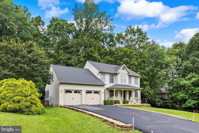 69 Cardinal Forest Dr, Fredericksburg, VA 22406 - view of front of property with an attached garage, asphalt driveway, a front yard, and a porch