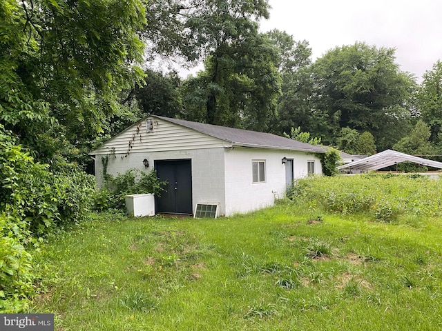5513 Taylor Rd, Riverdale, MD 20737 - view of property exterior featuring concrete block siding and an outdoor structure