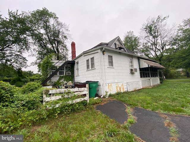 5513 Taylor Rd, Riverdale, MD 20737 - view of property exterior featuring a chimney, cooling unit, and a yard