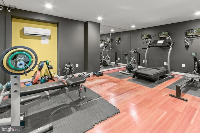 1314 Massachusetts Ave NW Unit 603, Washington, DC 20005 - gym with an AC wall unit, wood finished floors, and recessed lighting
