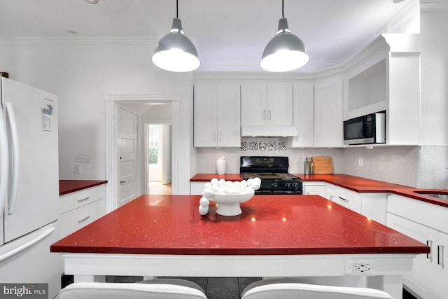 1329 Delafield Pl NW, Washington, DC 20011 - kitchen featuring black range, freestanding refrigerator, stainless steel microwave, under cabinet range hood, and dark countertops