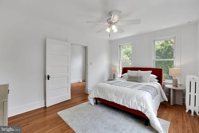 1329 Delafield Pl NW, Washington, DC 20011 - bedroom with radiator heating unit, light wood finished floors, and a ceiling fan