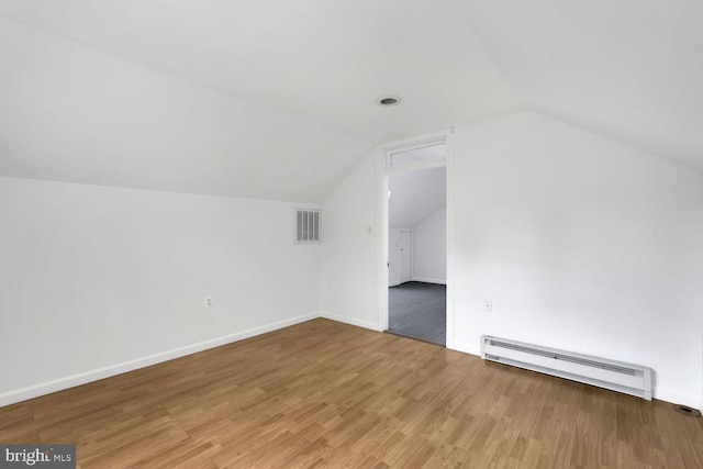 1329 Delafield Pl NW, Washington, DC 20011 - additional living space with a baseboard radiator, vaulted ceiling, and light wood-style flooring