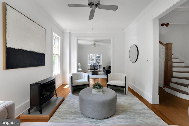 1329 Delafield Pl NW, Washington, DC 20011 - living area featuring a wood stove, ceiling fan, crown molding, wood finished floors, and stairs