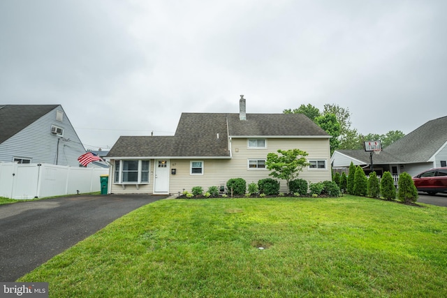 67 Neptune Ln, Levittown, PA 19054 - view of front of property with a chimney, asphalt driveway, and a shingled roof