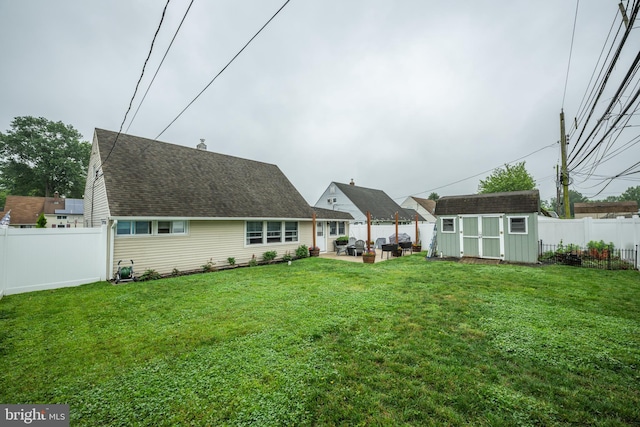 67 Neptune Ln, Levittown, PA 19054 - back of property featuring a storage unit, a fenced backyard, and a patio