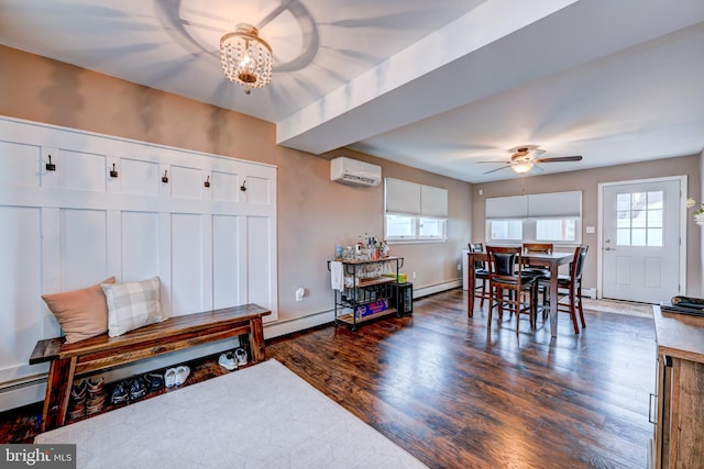 67 Neptune Ln, Levittown, PA 19054 - dining room with a wall mounted AC, baseboard heating, dark wood-style flooring, ceiling fan, and a chandelier