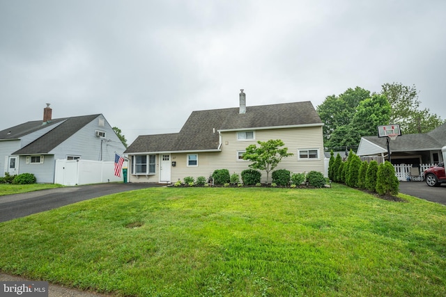 67 Neptune Ln, Levittown, PA 19054 - traditional-style house featuring asphalt driveway and a chimney